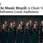 Concert scene featuring a choir and orchestra on a Brazilian stage during a touring program.
